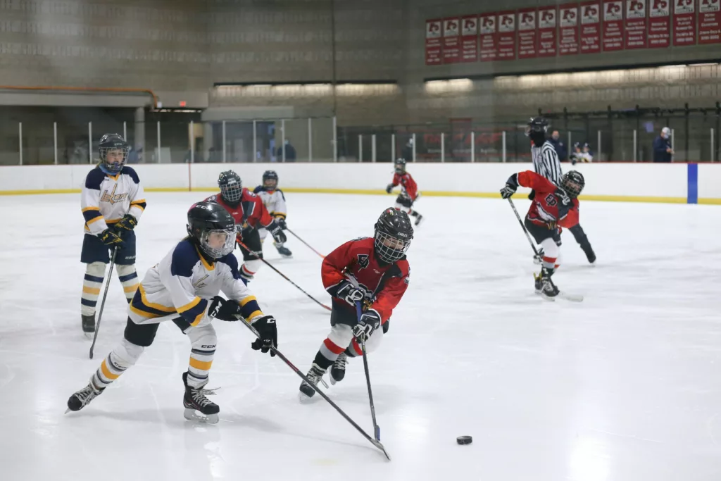 Action shot of players in a youth hockey game.